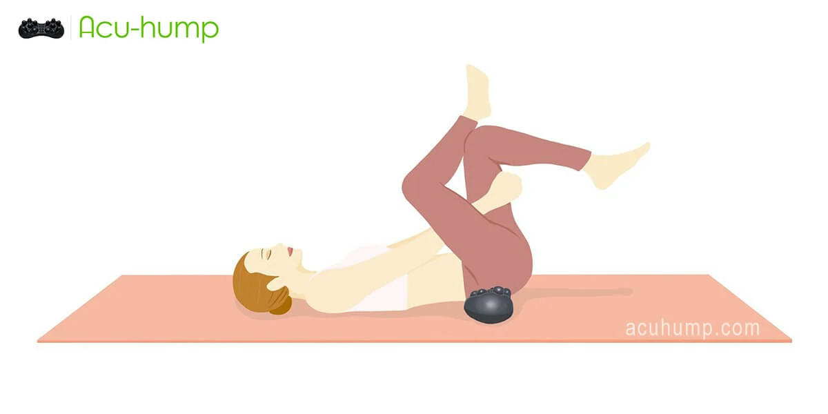 A woman places an Acu-hump under her buttocks to massage her buttock muscles and performs a figure-4 stretch to relax her piriformis muscles more quickly