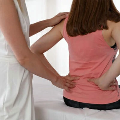 A doctor is examining a patient suffering from hip and butt pain