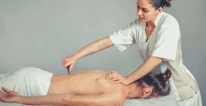 a women help a women with guasha for sciatica relief