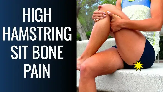 A woman is sitting on a chair with sit bone pain due to high hamstrings Tendinopathy