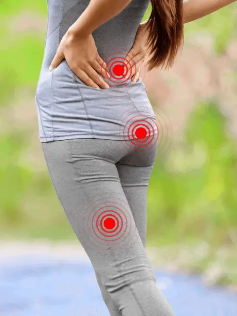 A woman suffering from sciatica in lower back down to buttocks and legs that won't go away and is suffering from painful attacks, holding her back